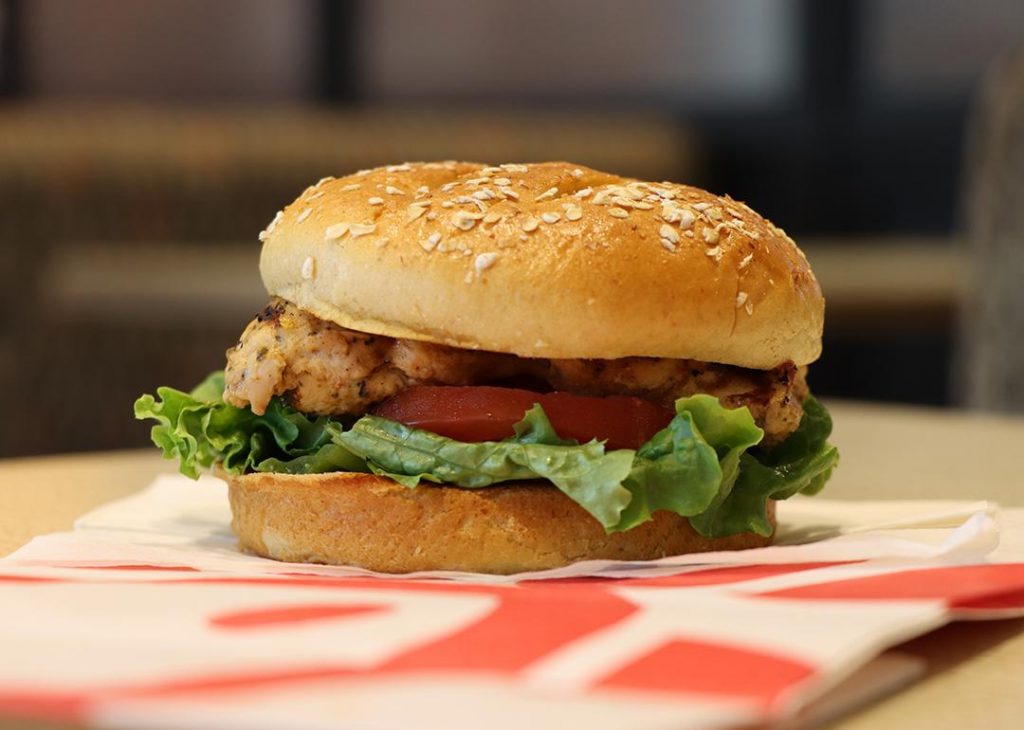 Soft bun rests gently over warm melting cheese