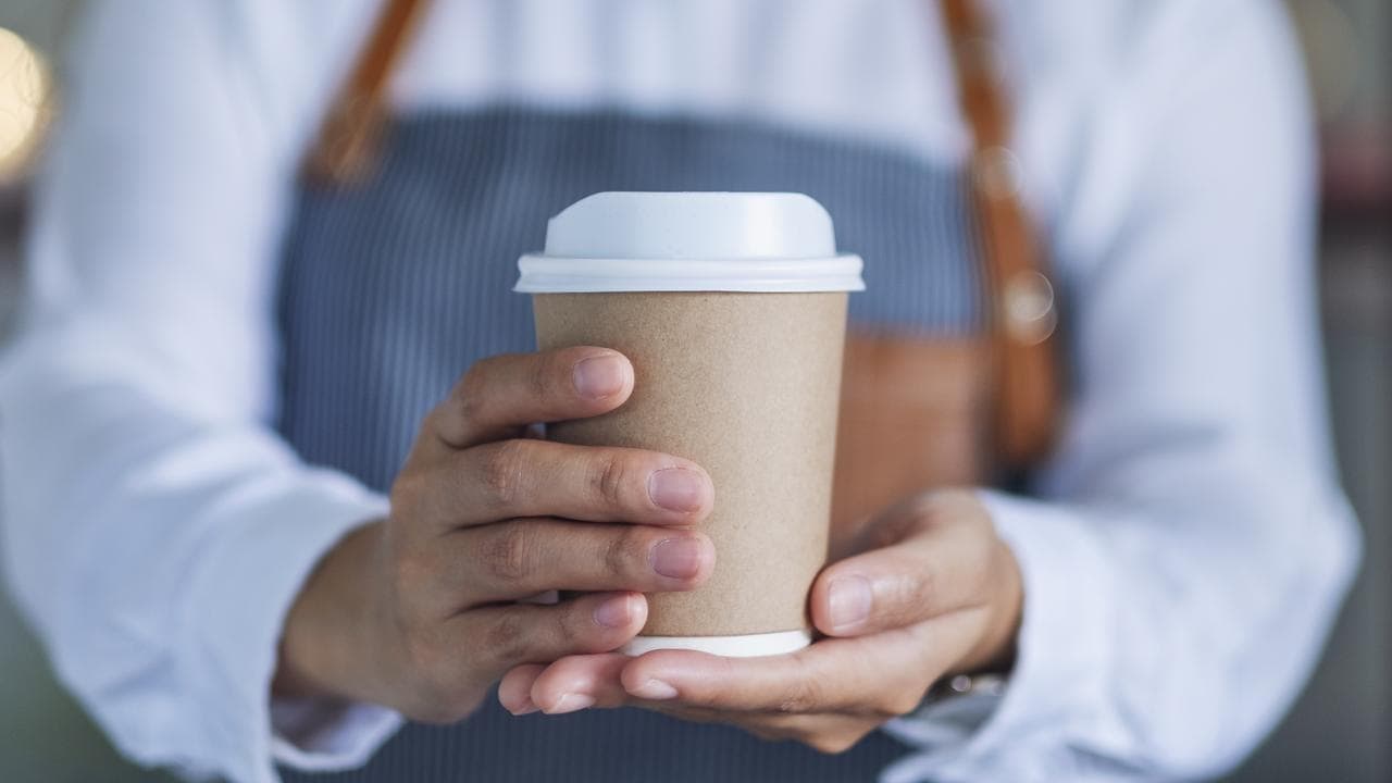 Portable hot coffee take away energizing a busy morning