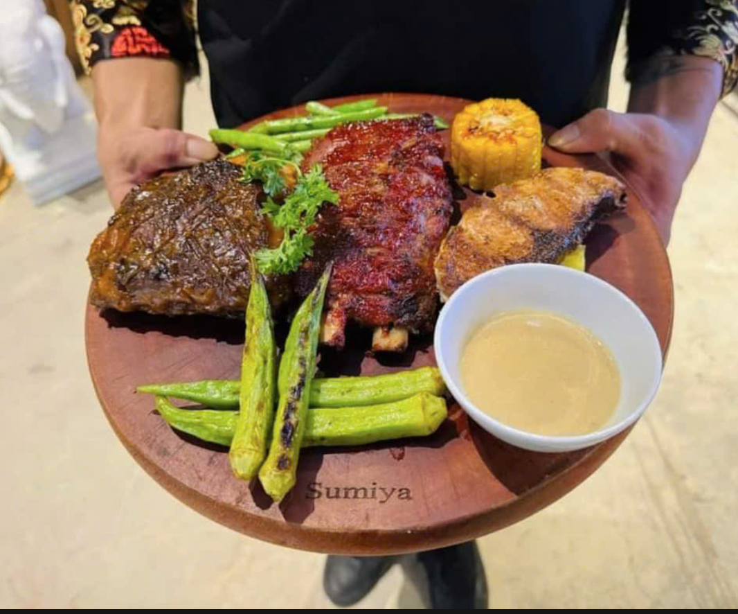 Refreshing drink paired with smoky ribs in a lively bar setting