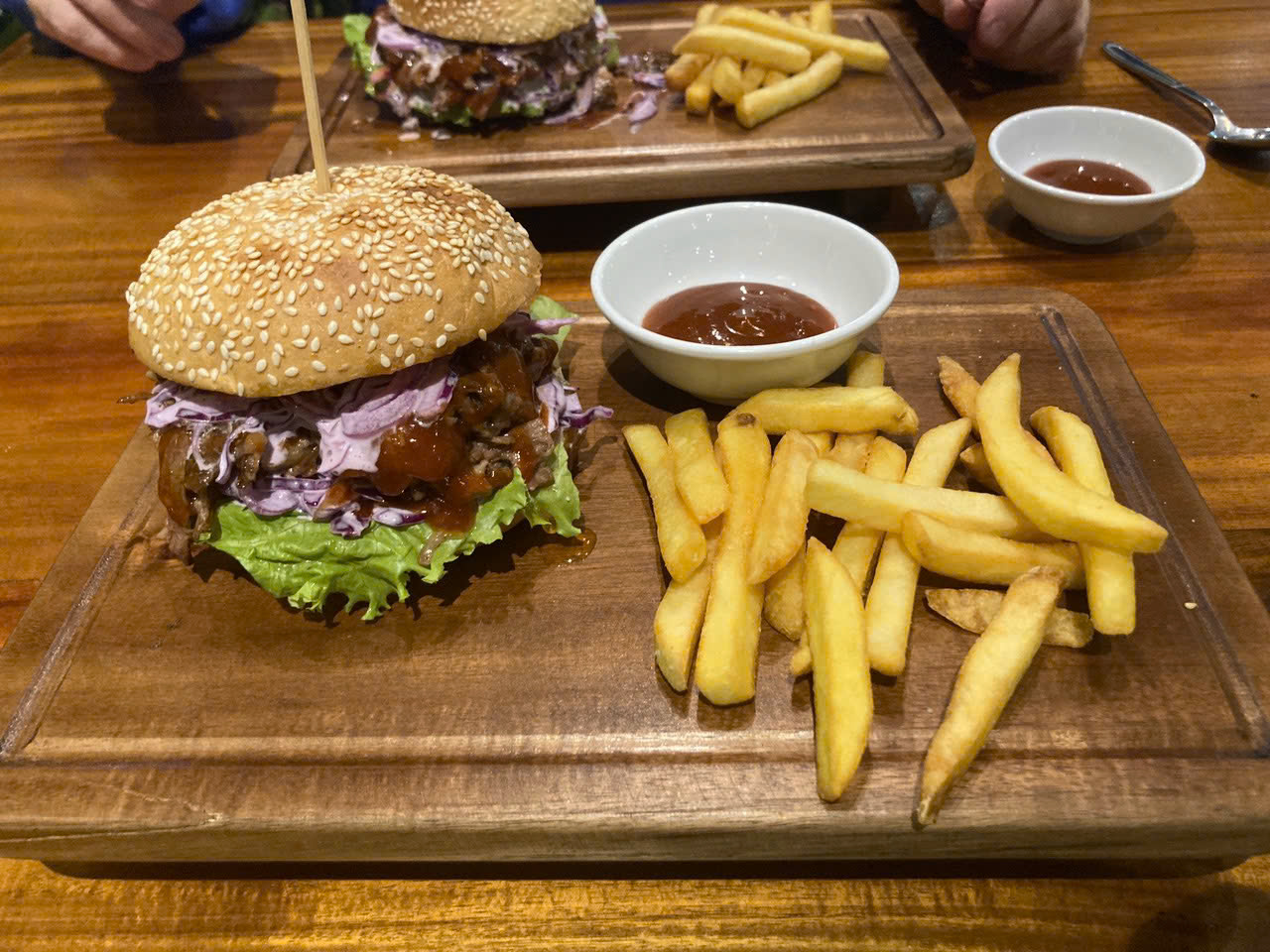 Juicy burger combo with fresh sides on a sunny table